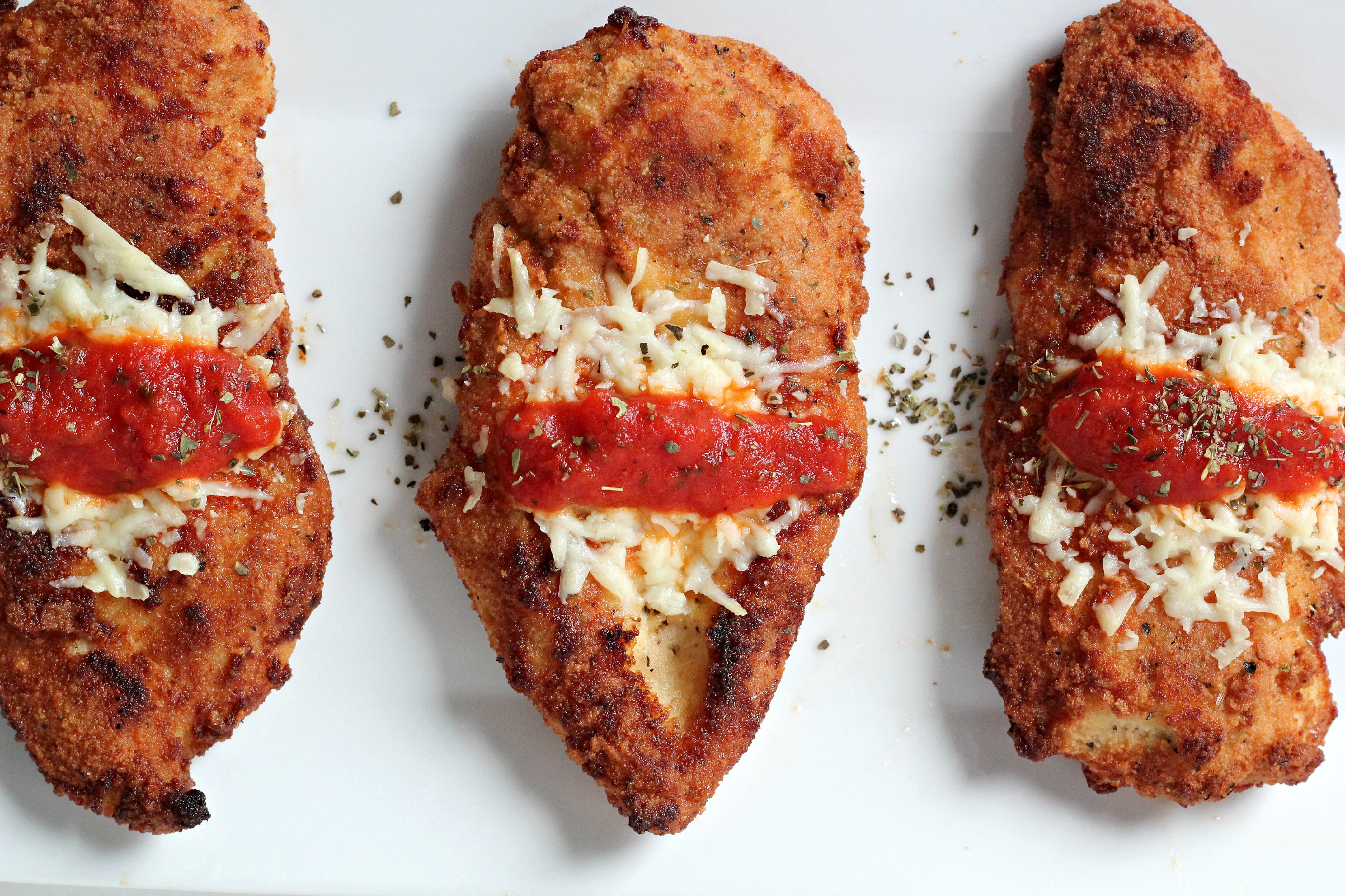 This is the best Grain Free Chicken Parmesan recipe! Make it for guests and they won't even know it's Paleo! 
